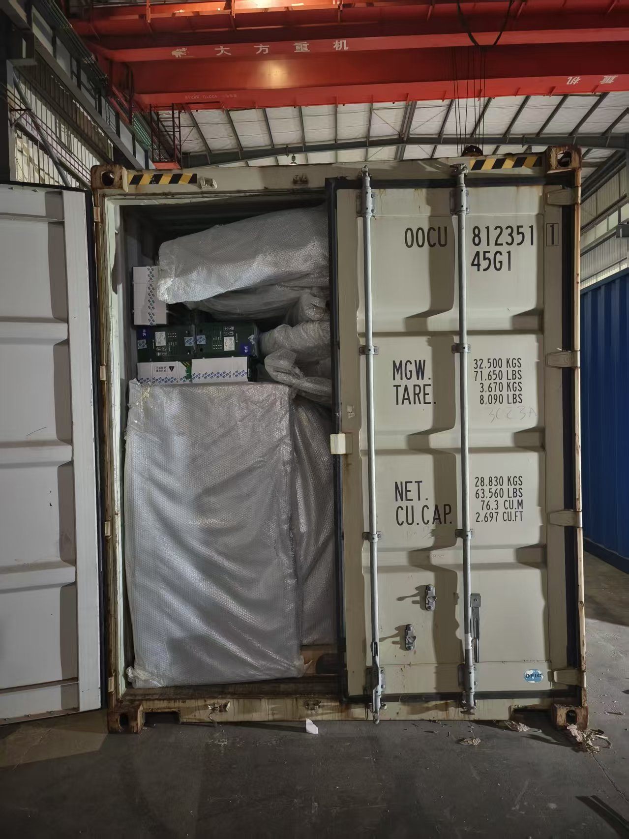 Open shipping container with protected components during loading