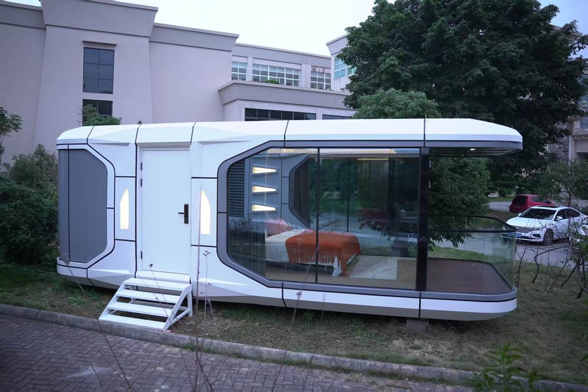 Side view of installed capsule cabin with deck and glass facade